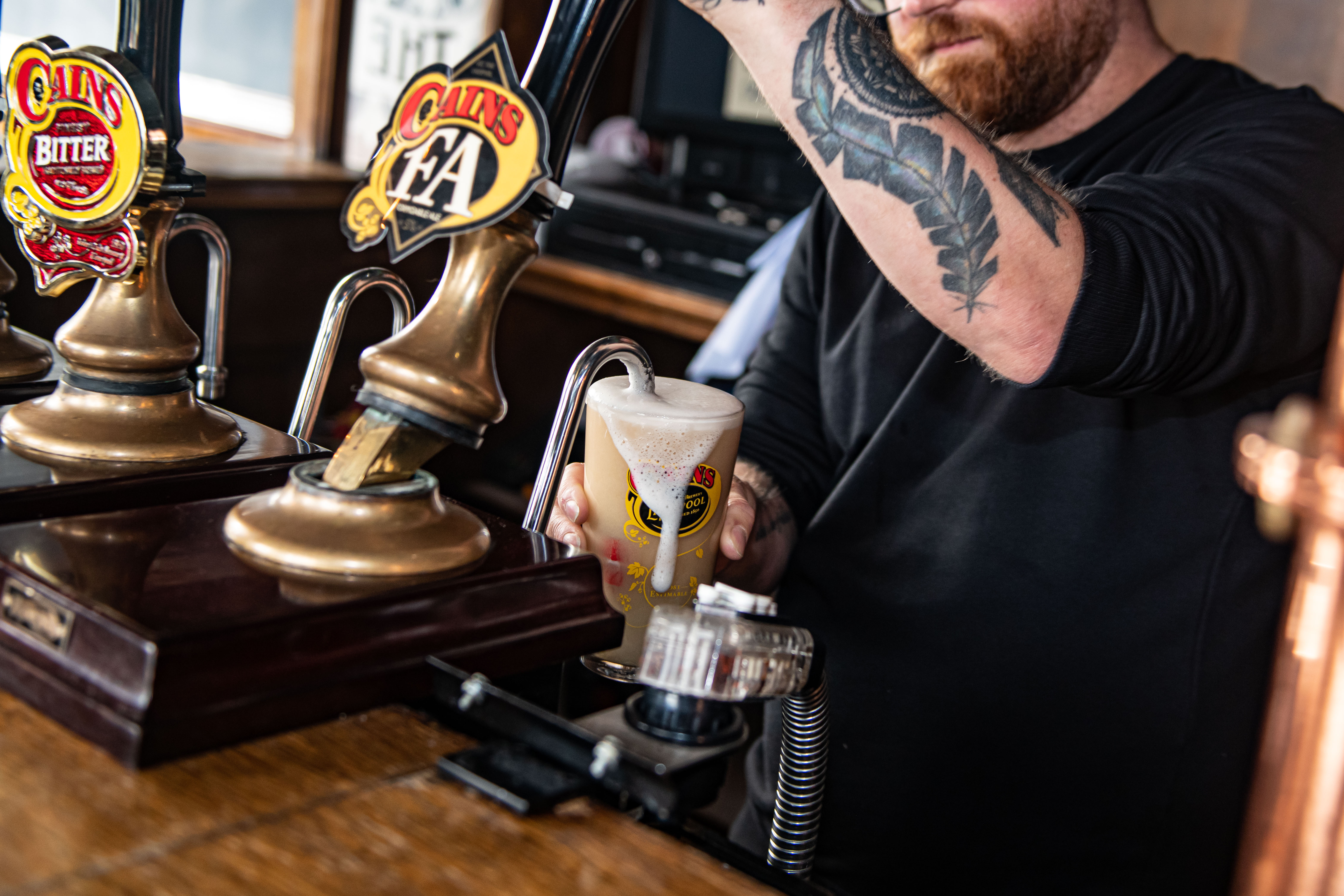 Bartender pouring draft beer at The Brewery Tap, showcasing quality beverage service for events.
