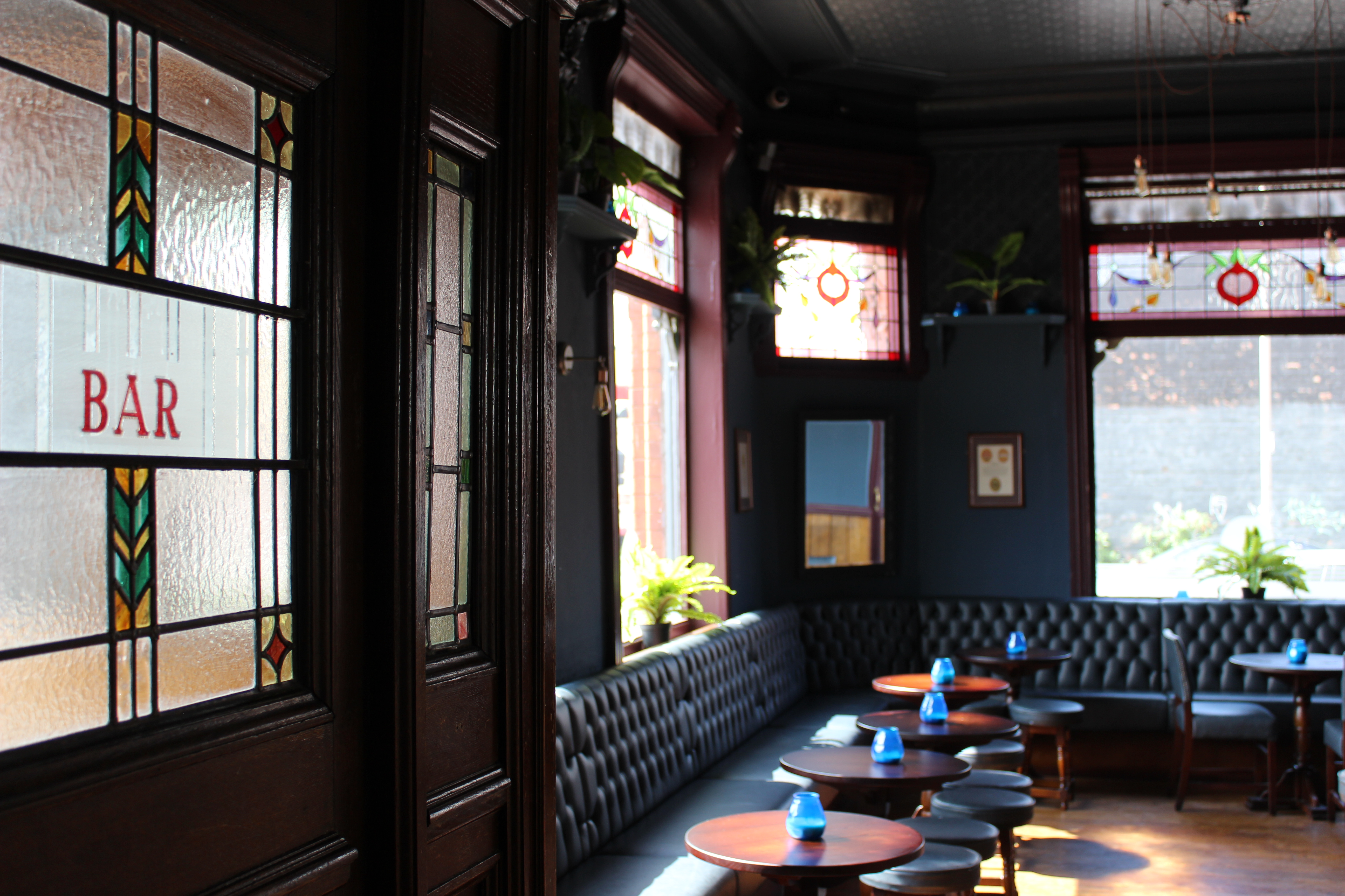Stylish bar area with stained glass at The Brewery Tap, perfect for networking events.