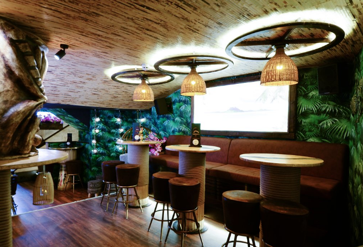 Intimate event space at Laki Kane with warm lighting and lush greenery for gatherings.