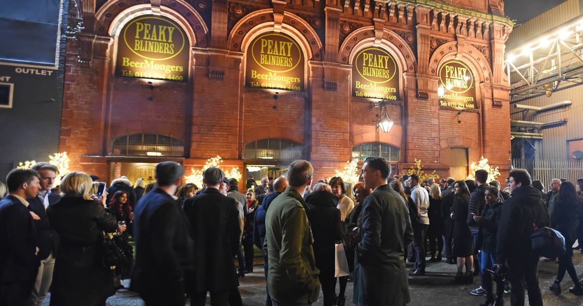 Upstairs bar at Peaky Blinders Liverpool, vibrant outdoor event with engaged crowd.