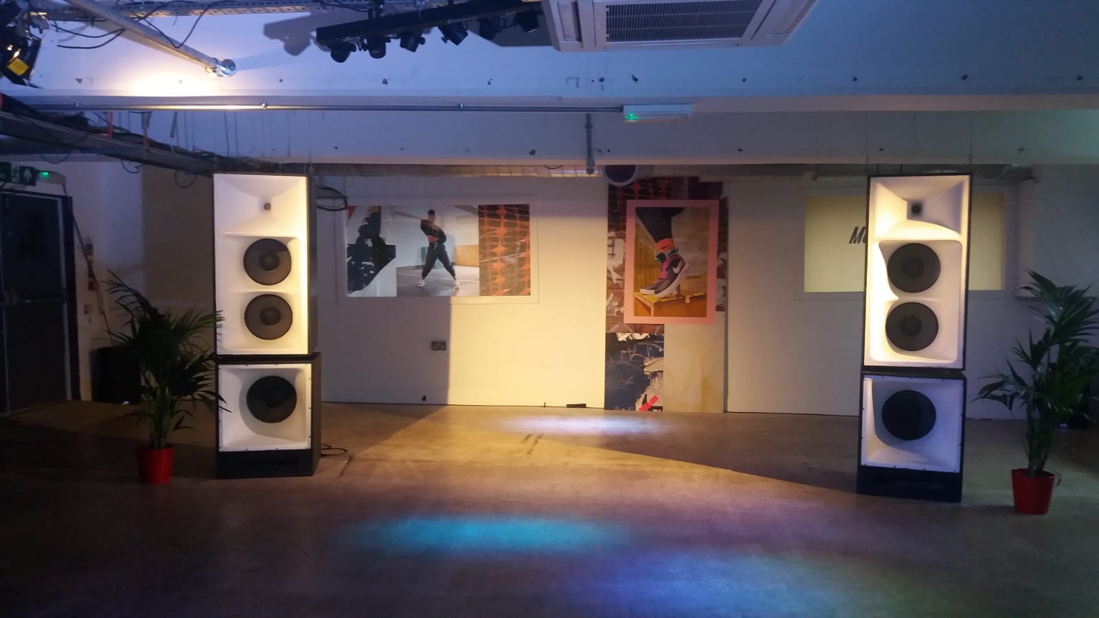 Versatile event space in Peckham Gallery with sound speakers and artistic decor.