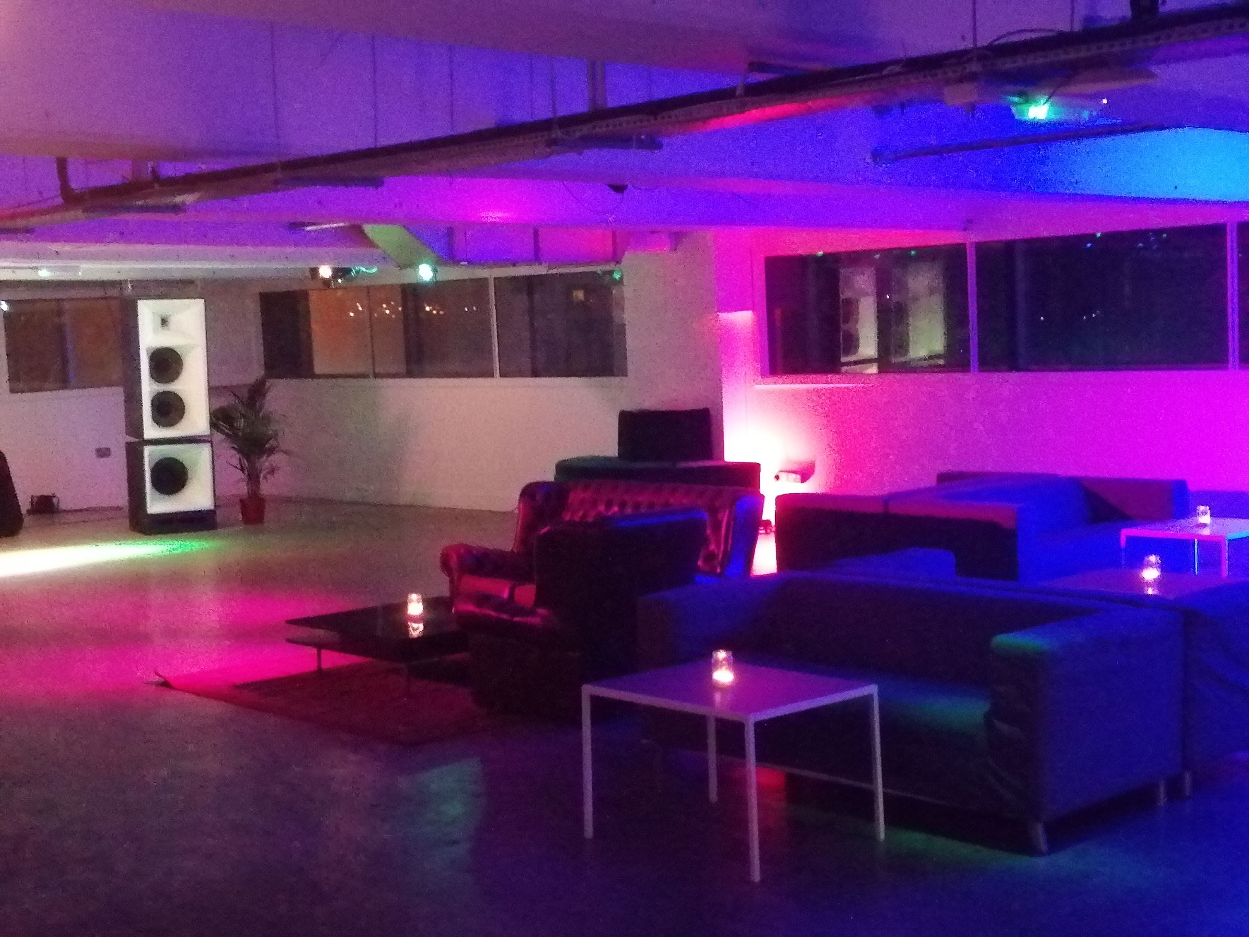 Stylish event space in Peckham Gallery with modern seating and ambient purple lighting.