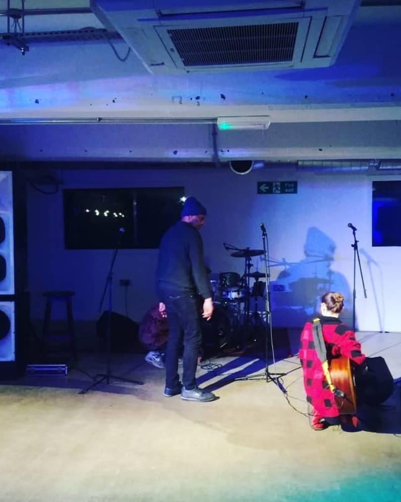 "Peckham Gallery performance space setup with stage, sound, and lighting for live event."