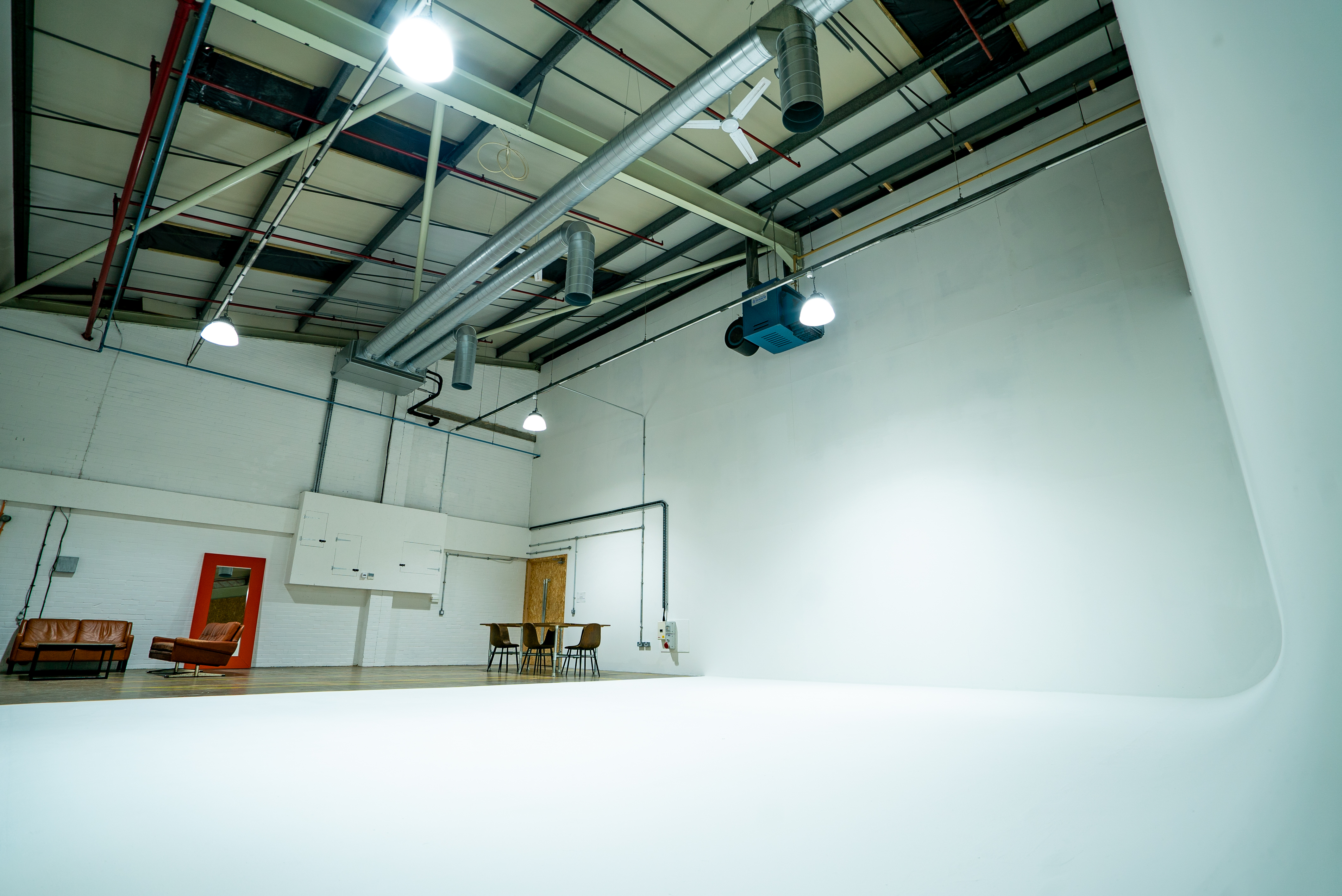 Versatile event space with white backdrop for presentations and workshops.