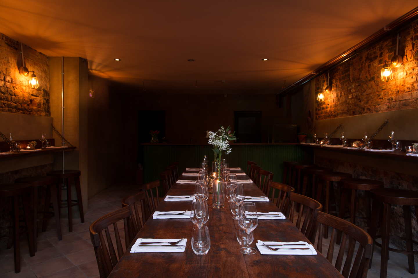 Private dining wine cellar in Maremma with rustic decor for intimate corporate events.