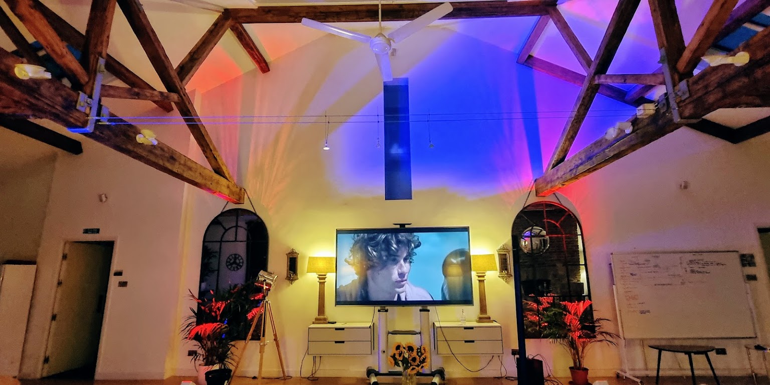 Stylish Shoreditch Loft venue with large screen, ideal for corporate events and gatherings.