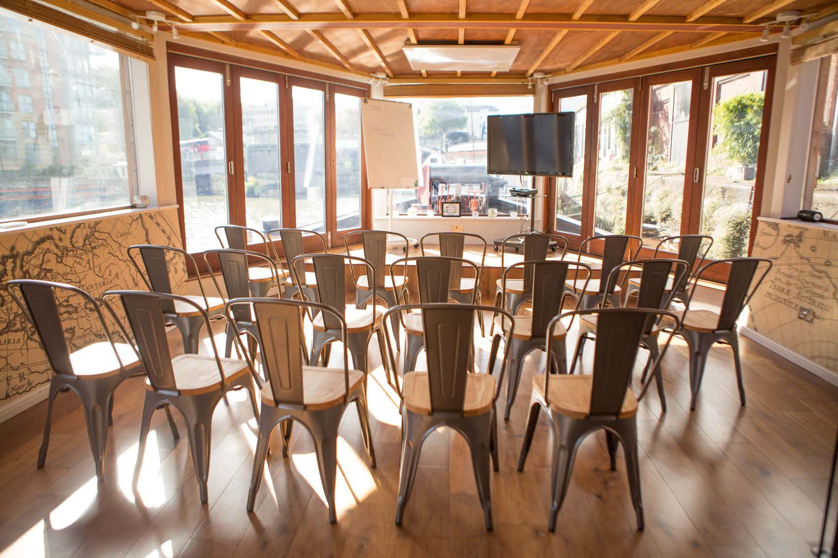 Well-lit meeting space with circular metal chairs for workshops in Floating Harbour.