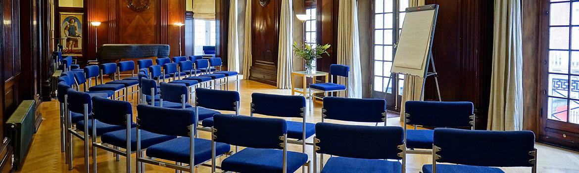 Meeting space at The Mandeville Hotel with blue chairs for workshops and presentations.