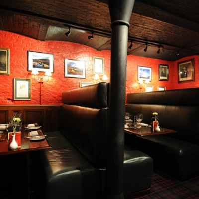 Cozy Boisdale restaurant with red walls, ideal for private dining and meetings.