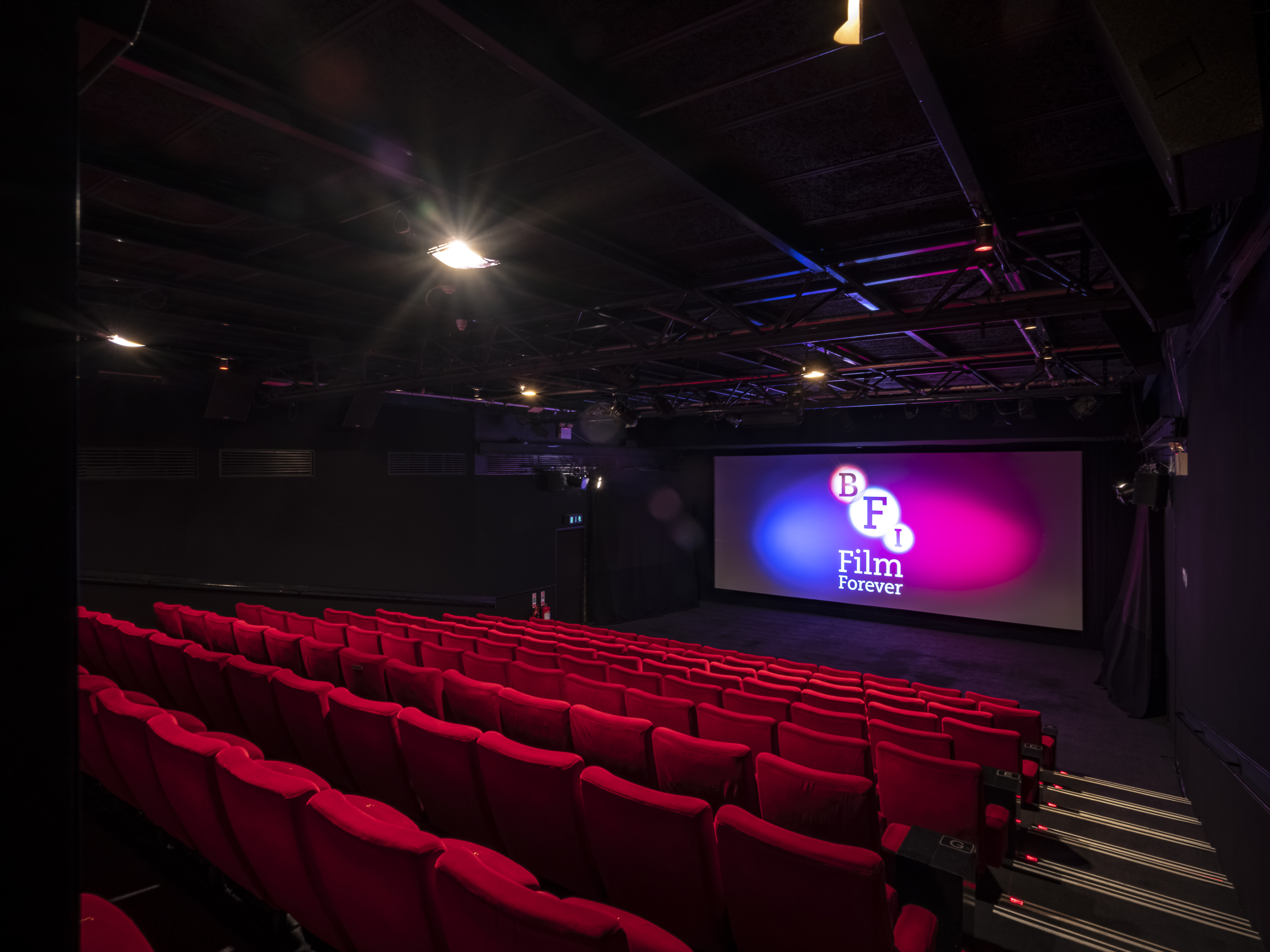 Modern cinema at BFI Southbank with vibrant red seating for film screenings.