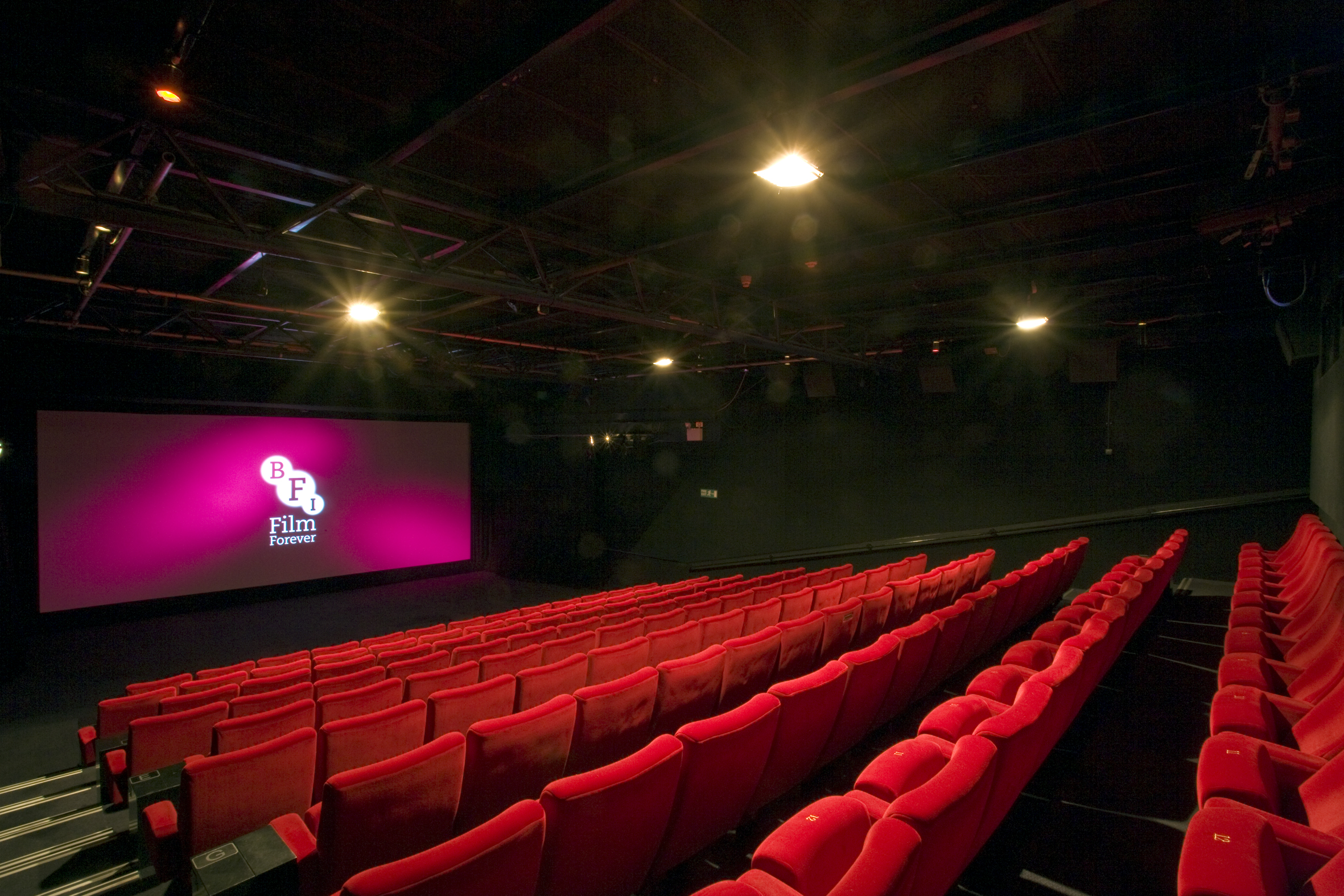 Modern screening room at BFI Southbank with plush red seating for film festivals.