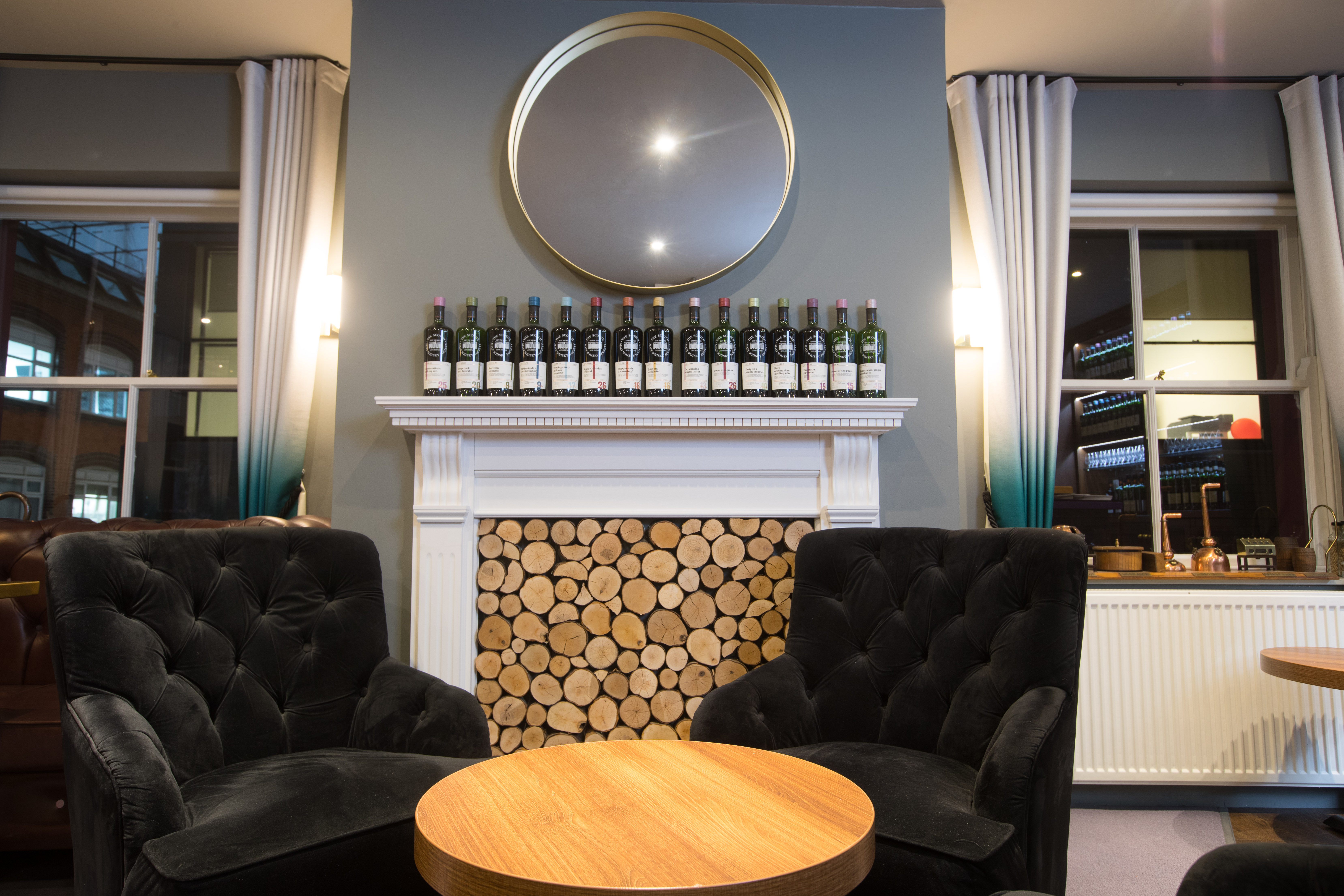 Stylish SMWS private meeting room with plush armchairs, perfect for networking events.
