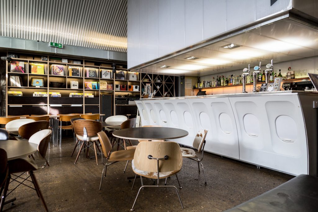 Modern venue at Number 10 London with unique airplane fuselage bar for networking events.