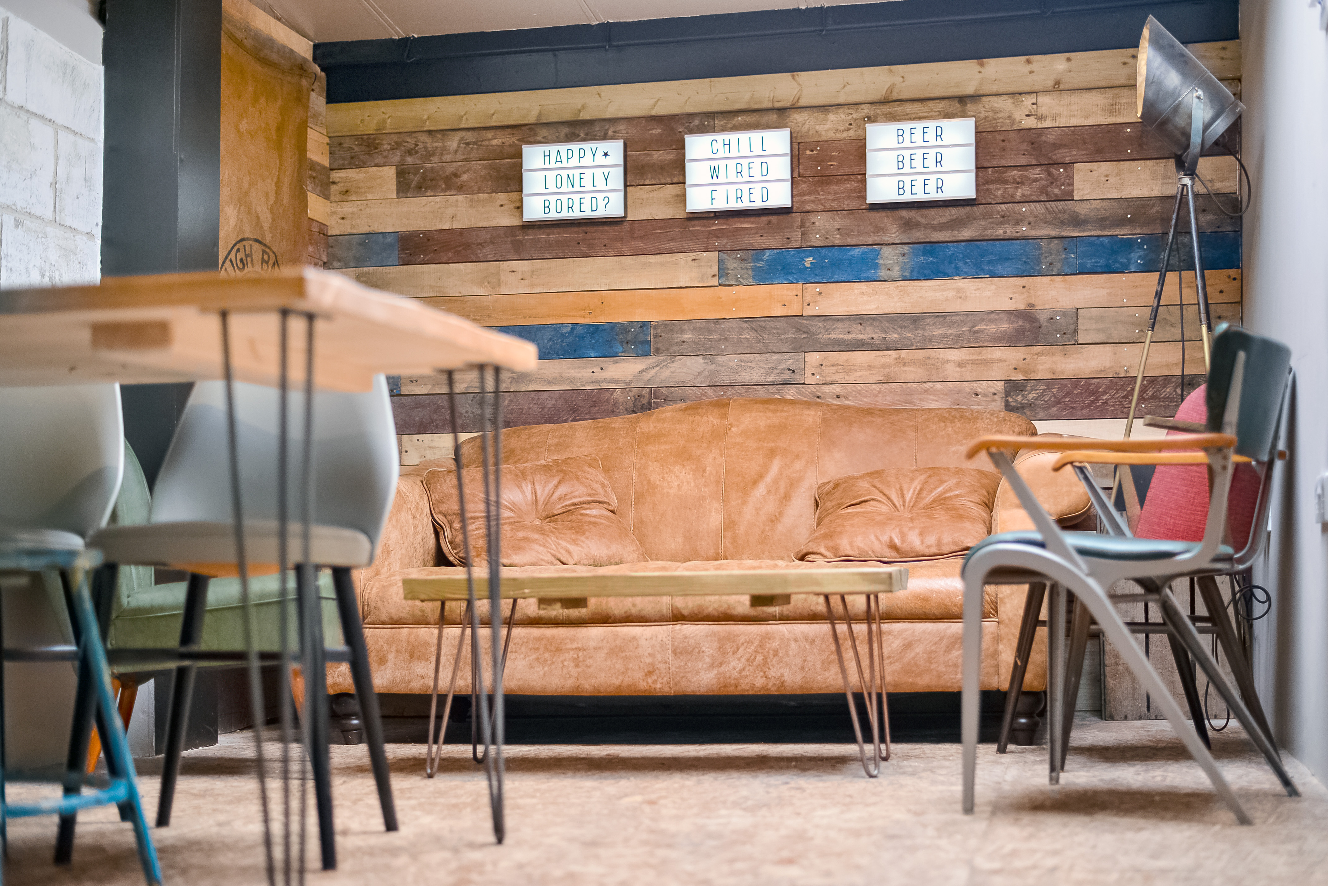Cozy Taproom at Sambrook's Brewery with leather couch, ideal for meetings and workshops.