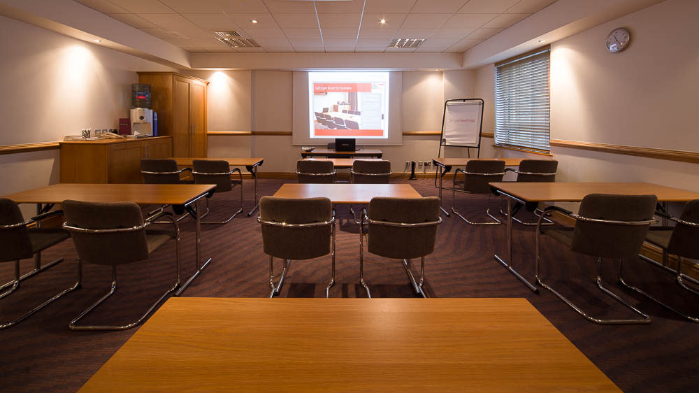 Meeting room setup with projector screen for professional events in Jury's Inn Glasgow.