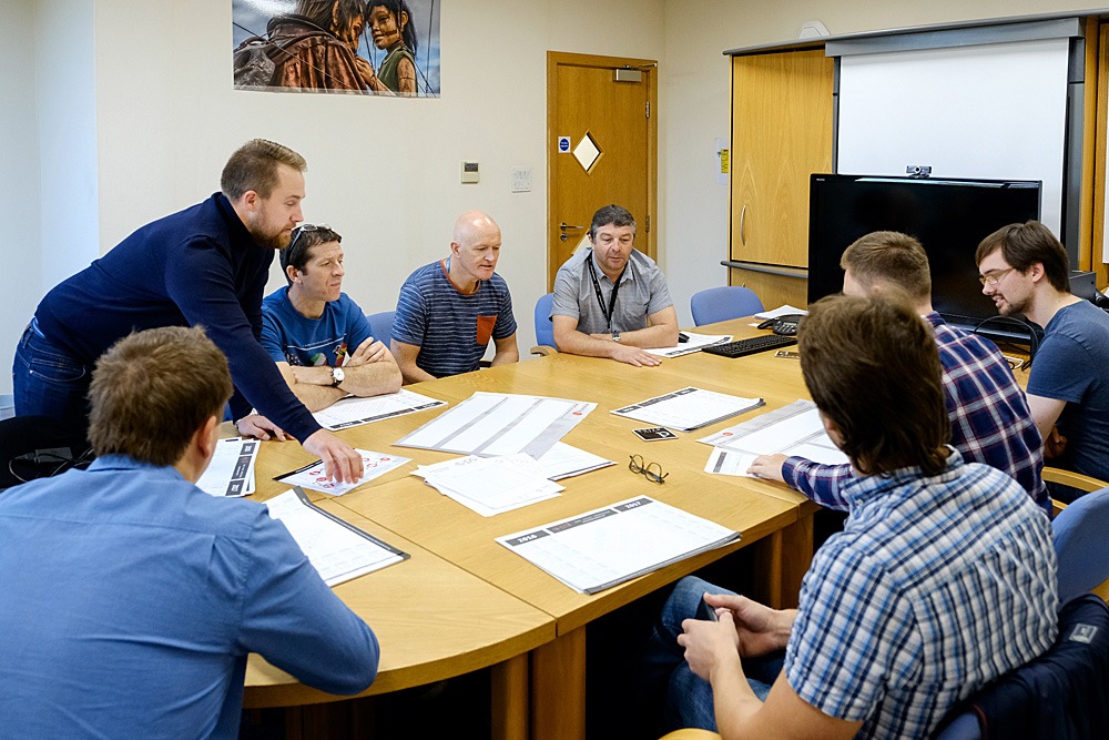 Collaborative meeting in Powder Systems Limited conference room, showcasing teamwork and planning.