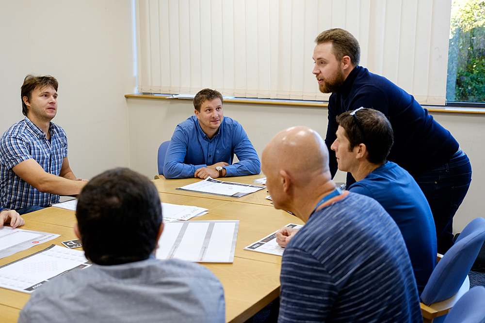 Conference room meeting with engaged participants, ideal for brainstorming and strategy sessions.
