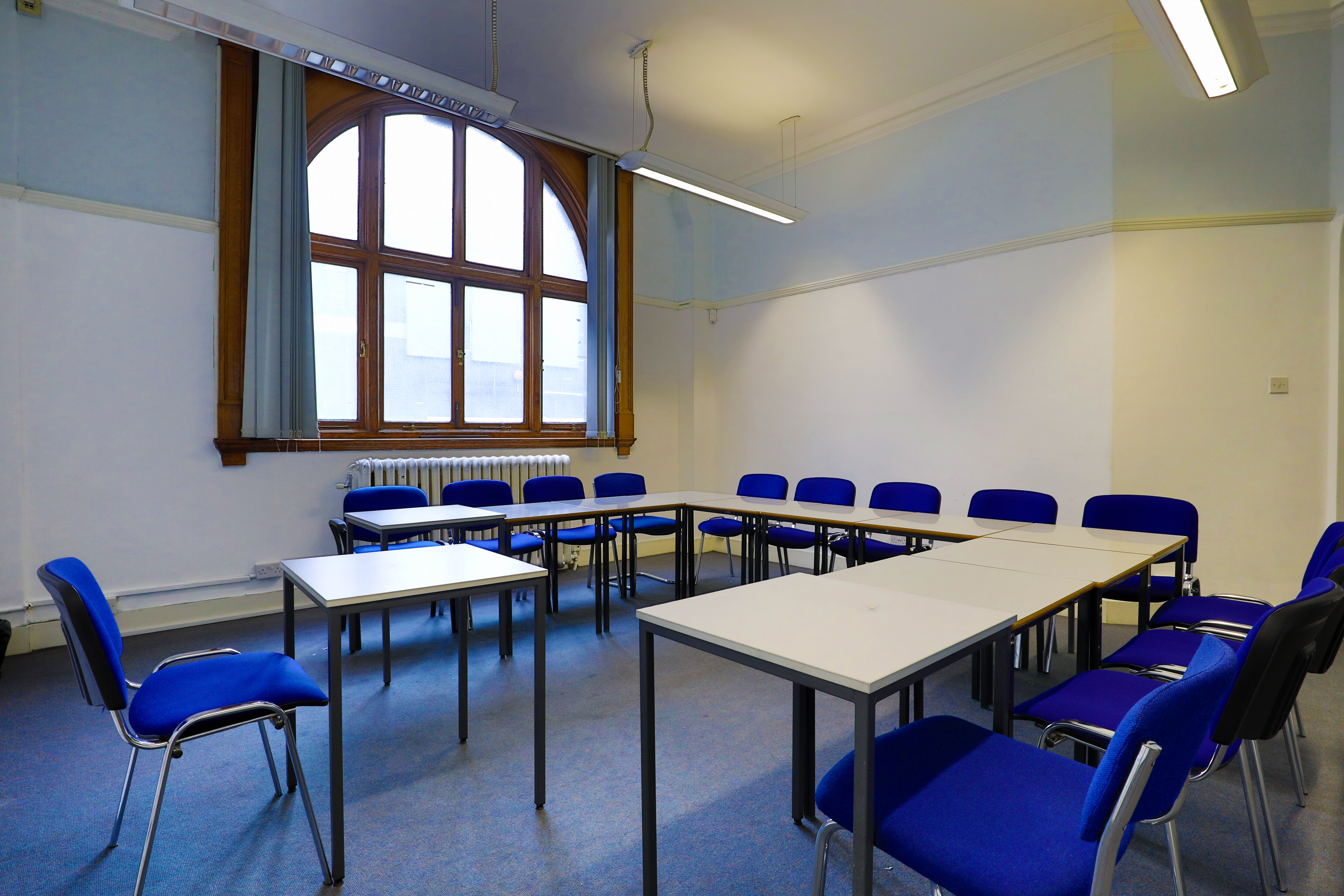 Conference Room at Philip Training Centre with blue chairs, ideal for workshops and meetings.