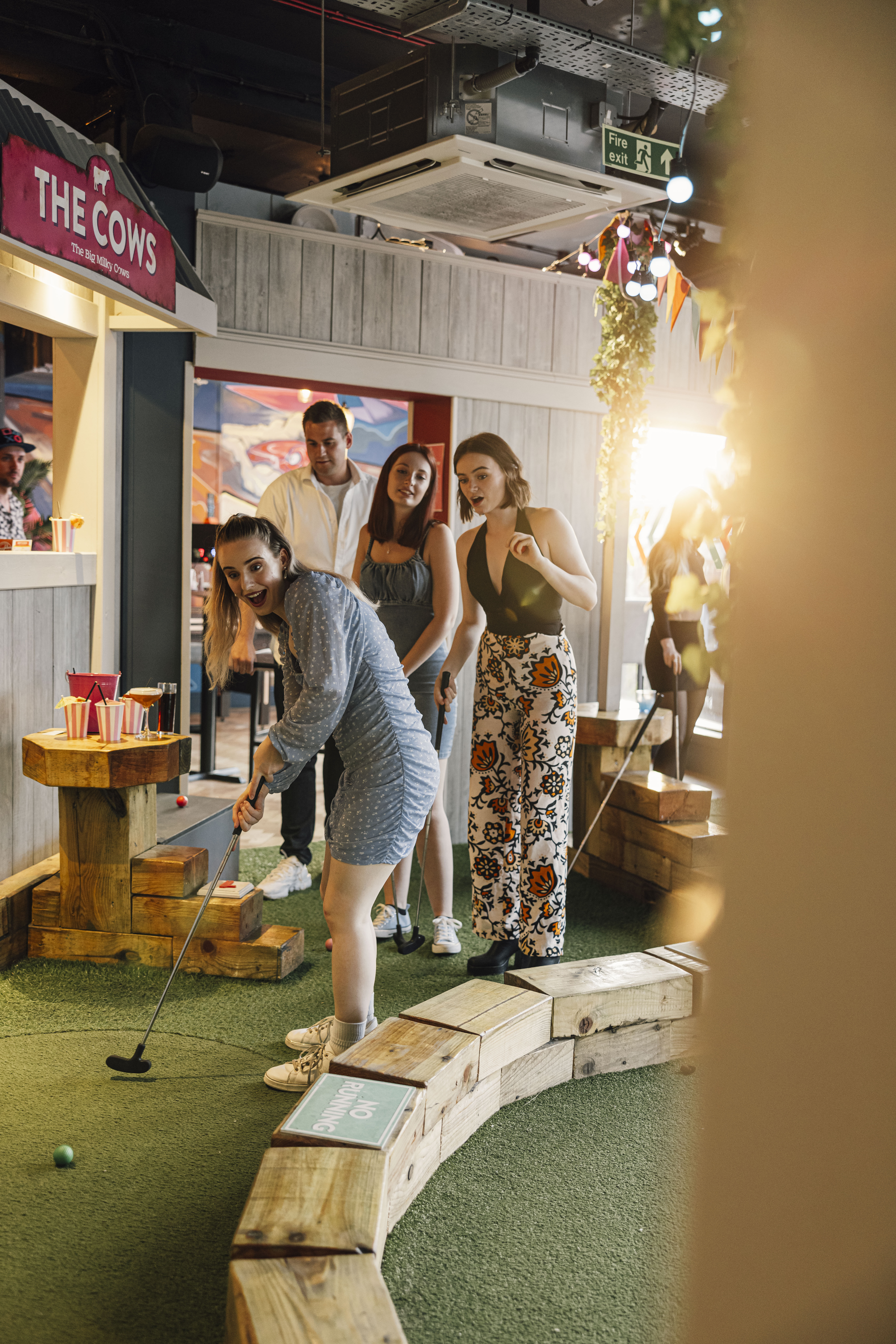 Lively networking event at Caddies Southend with colorful decor and casual attire.