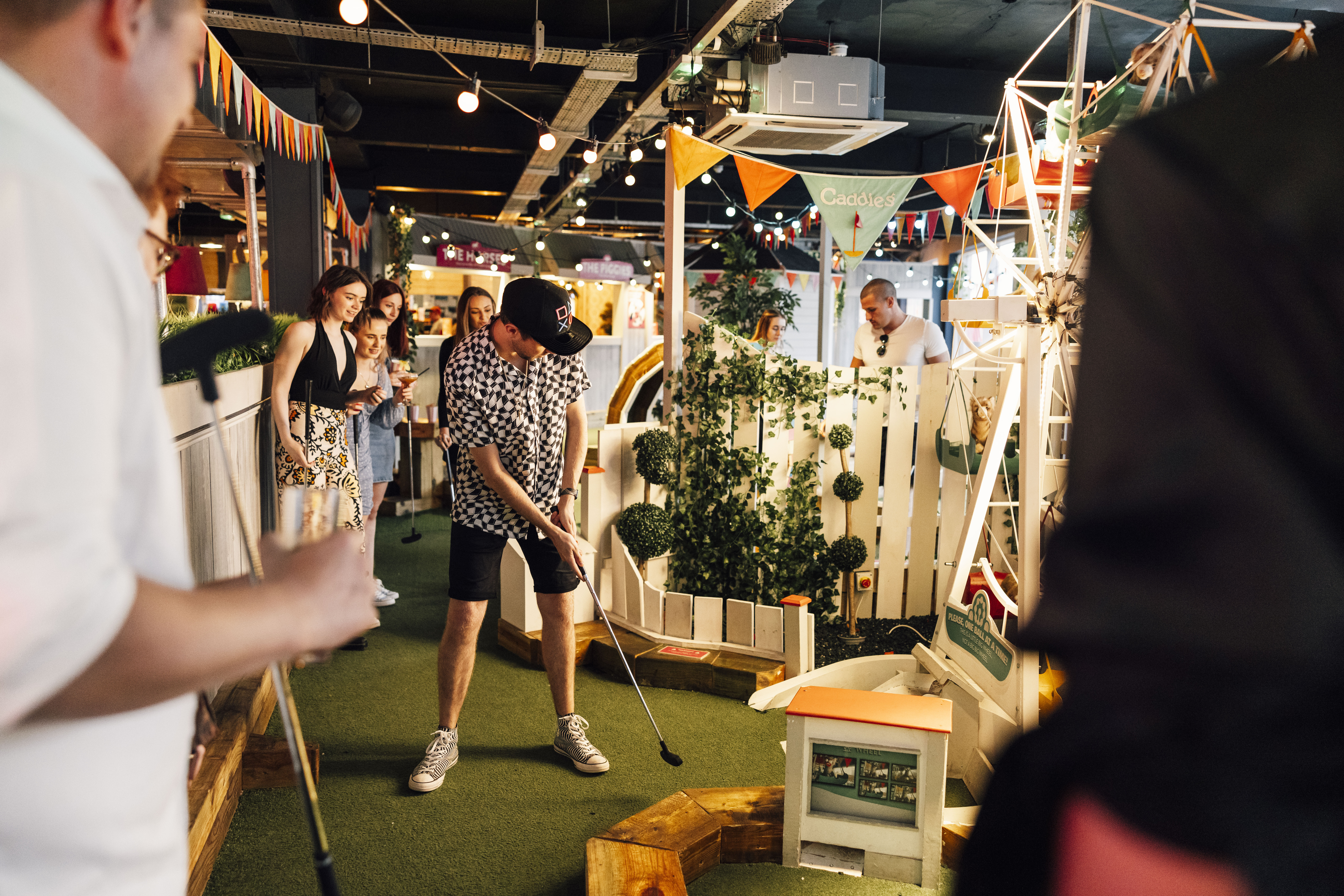 Vibrant mini-golf event at Caddies Southend, perfect for team-building and networking.