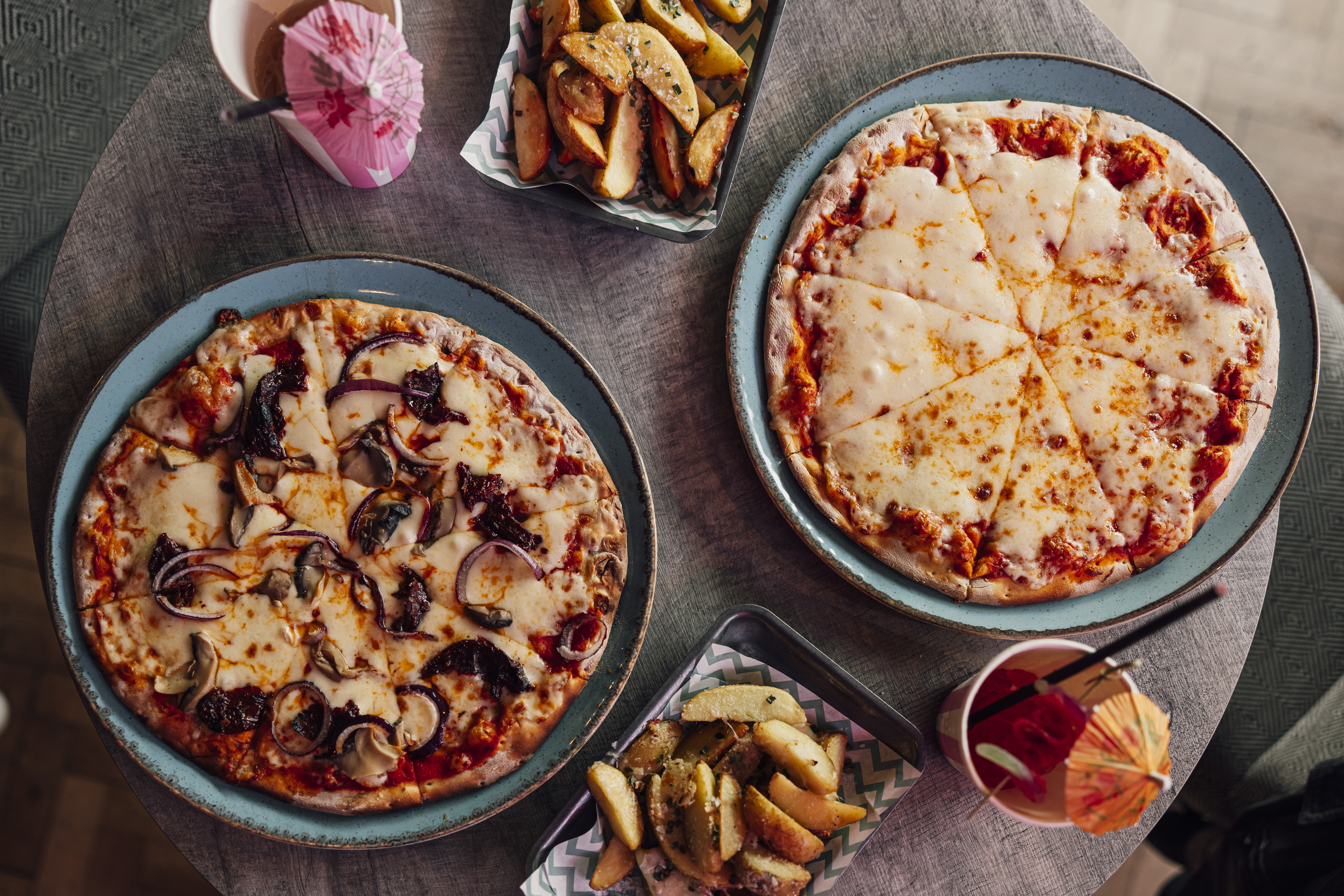 Whole Venue at Caddies Southend with vibrant pizzas and snacks for events and meetings.