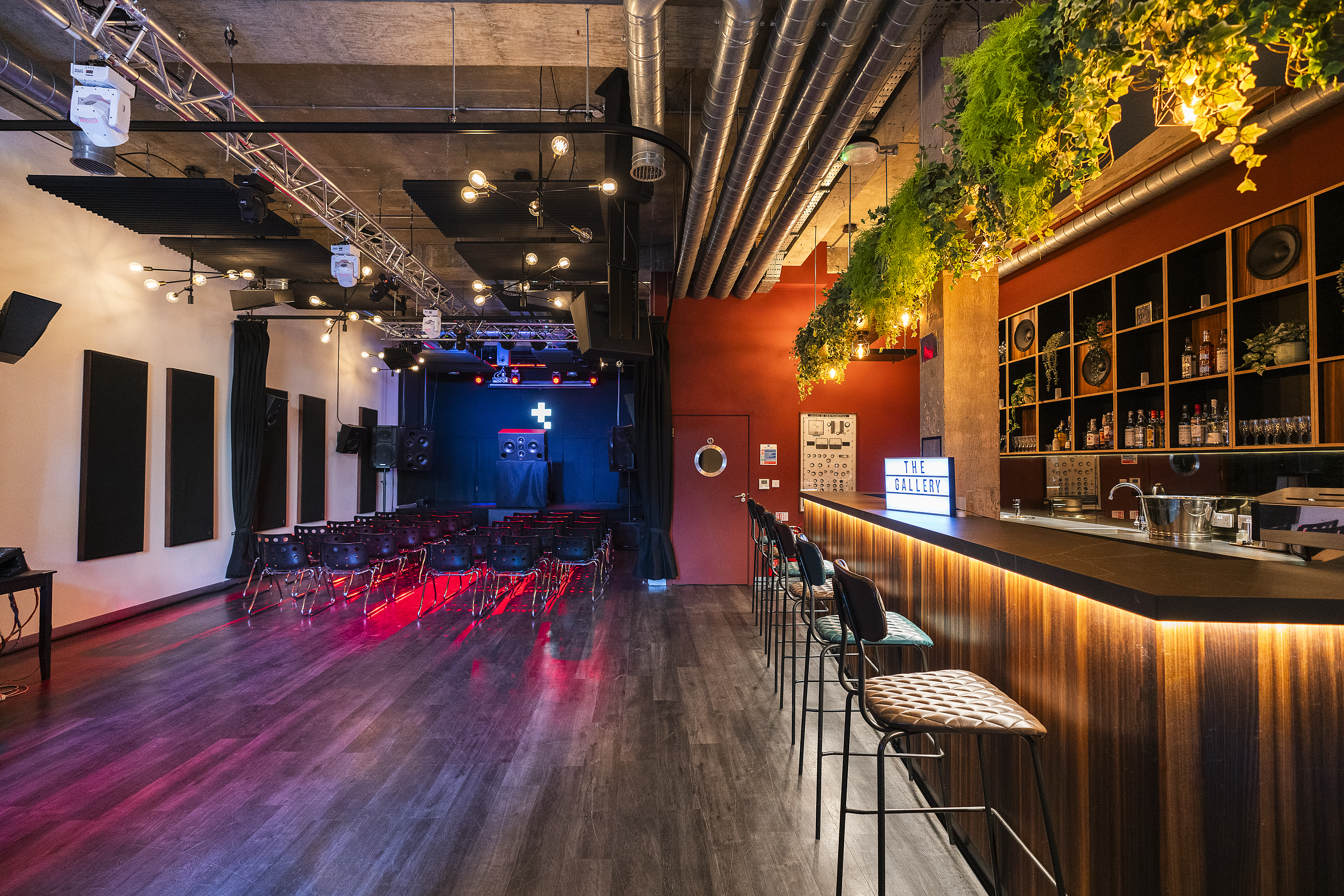 Versatile event space in The Gallery, Tileyard London with sleek bar and stage.