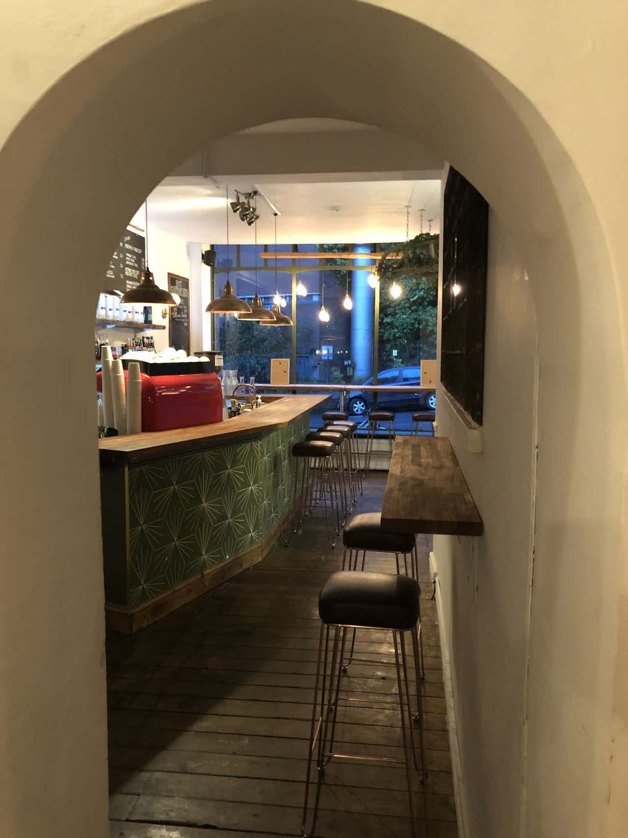 Cozy café venue in Archie's with stylish bar, ideal for informal meetings and events.