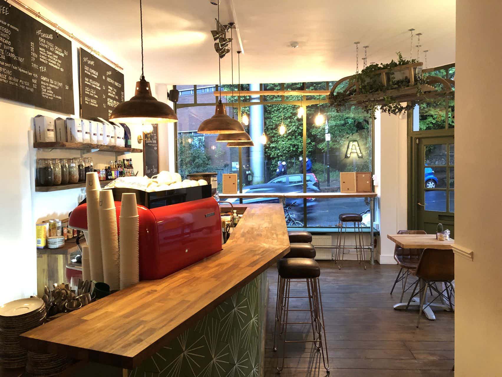 Cozy café venue at Archie's with warm lighting for networking events and meetings.