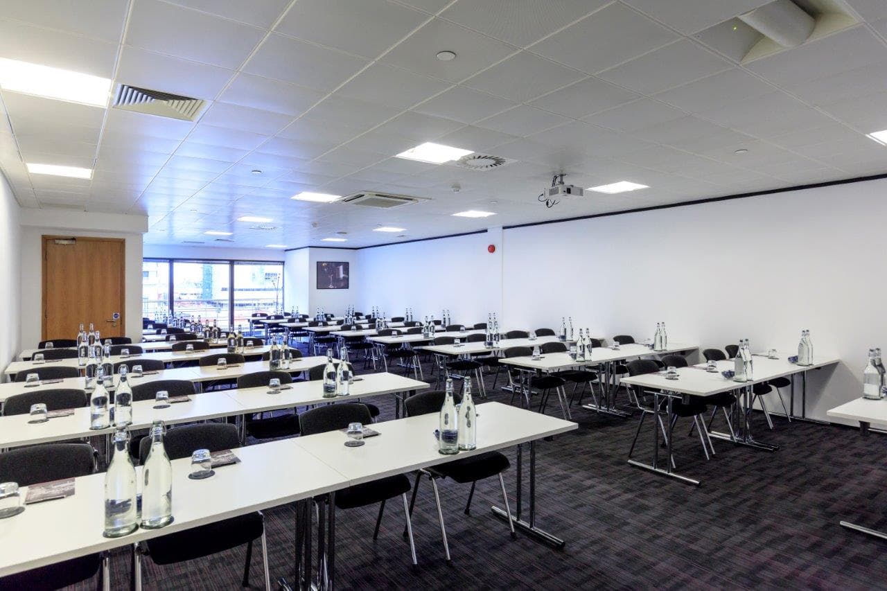Madeira Room corporate meeting setup with linear tables for business events and seminars.