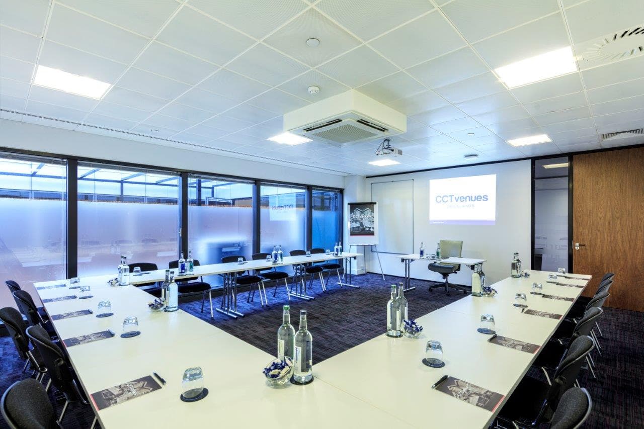 U-shaped Teak Room with ergonomic seating for professional board meetings and training workshops.