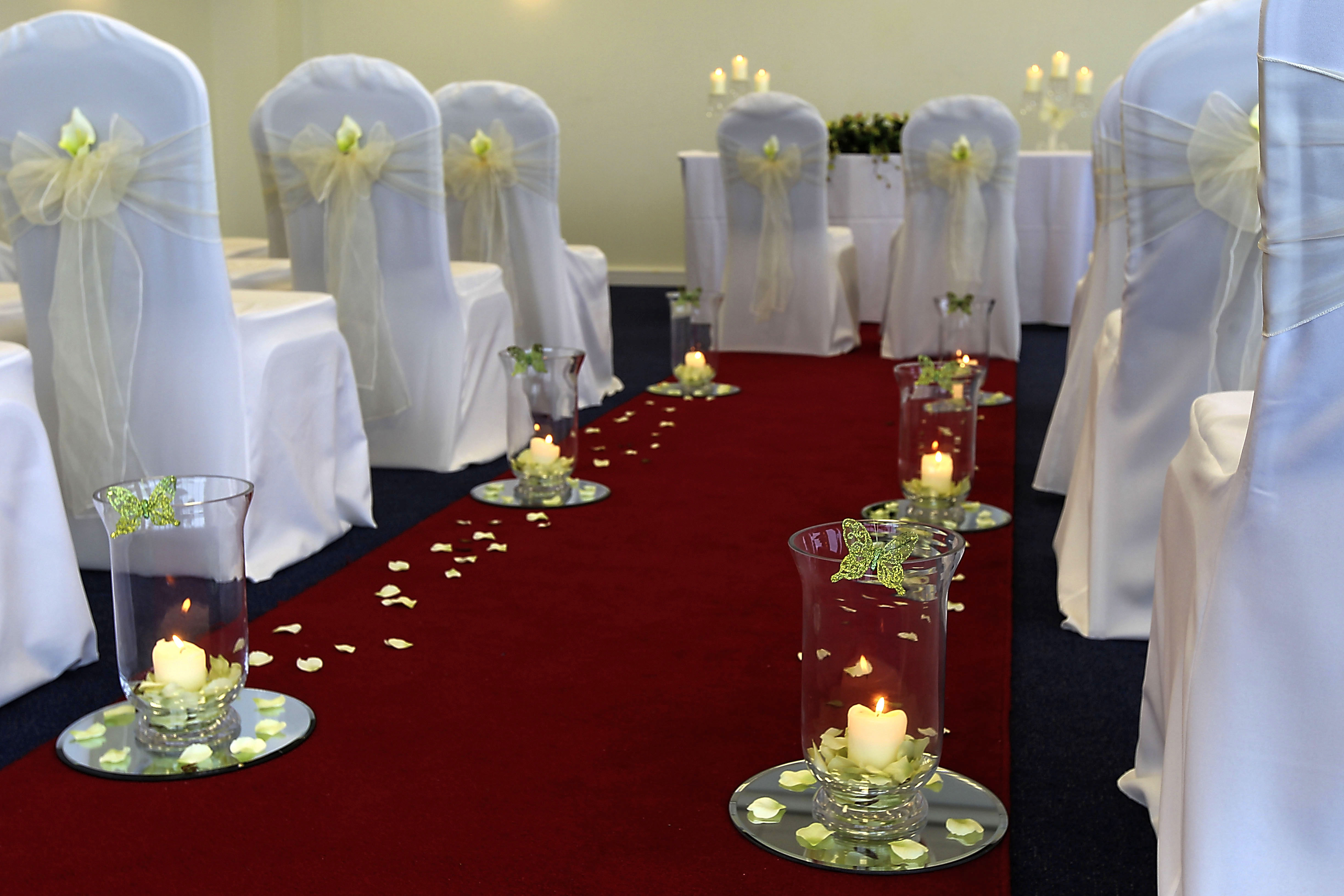 Hindlip Suite at Sixways Stadium, elegant wedding venue with red carpet and candle decor.