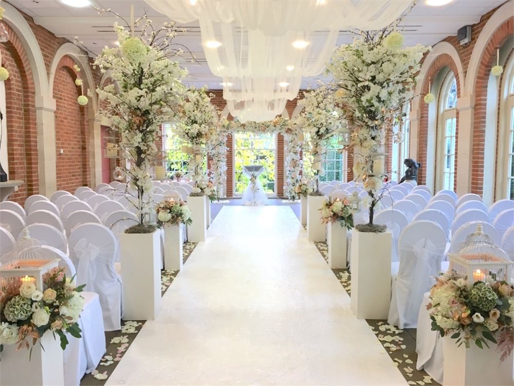 Orangery wedding venue with elegant chairs and floral decor for romantic ceremonies.