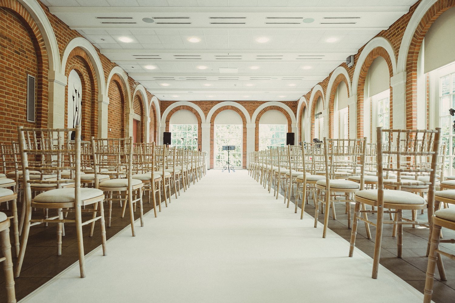 Orangery event space with chiavari chairs, perfect for ceremonies and gatherings.