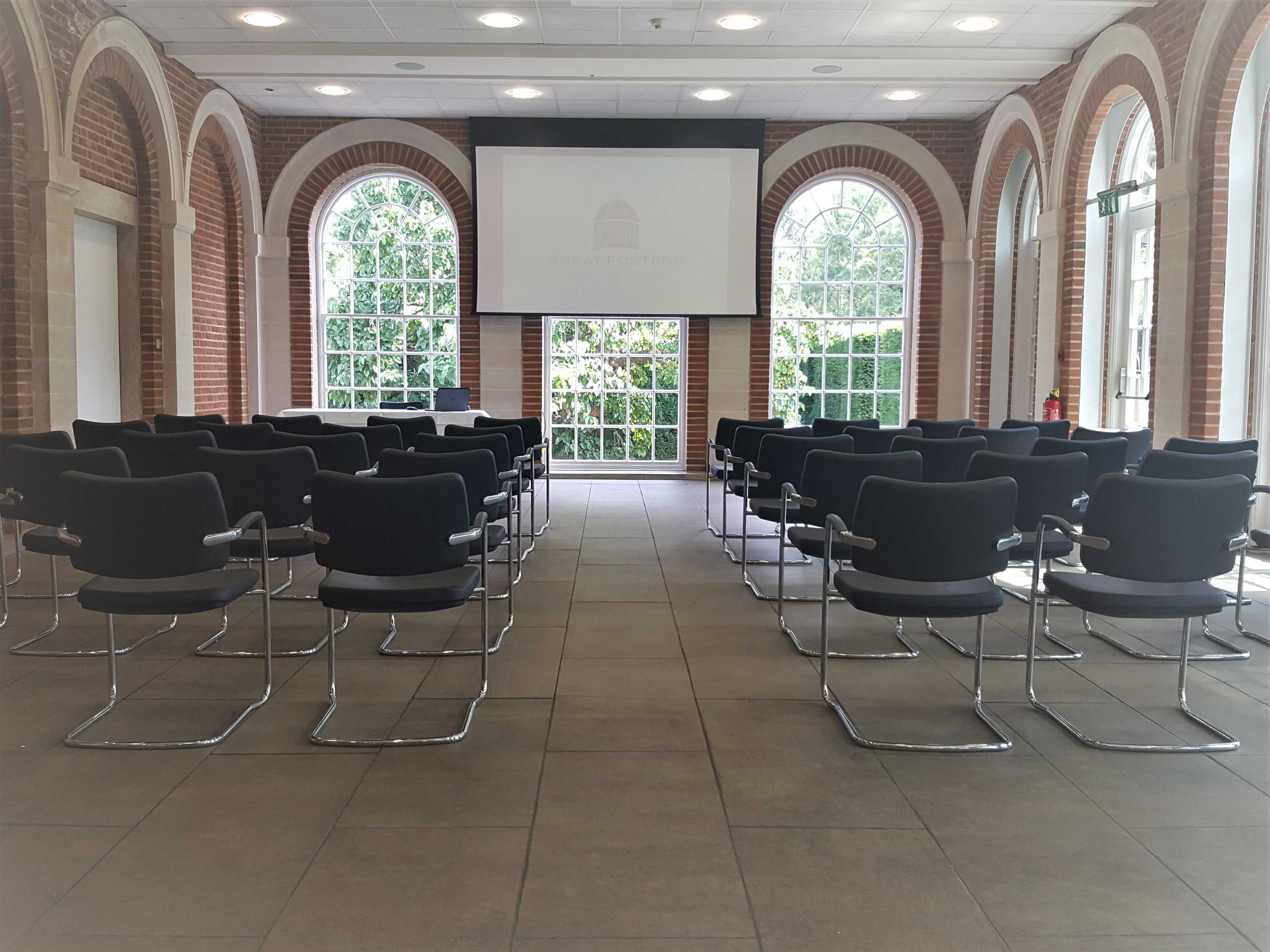 Orangery meeting space with modern chairs, ideal for workshops and seminars.