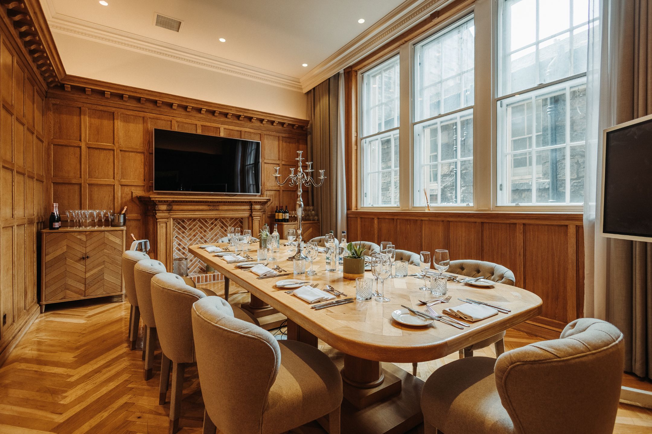 The Dalmore boardroom at Scotsman Hotel, wood-paneled venue for executive meetings and events.
