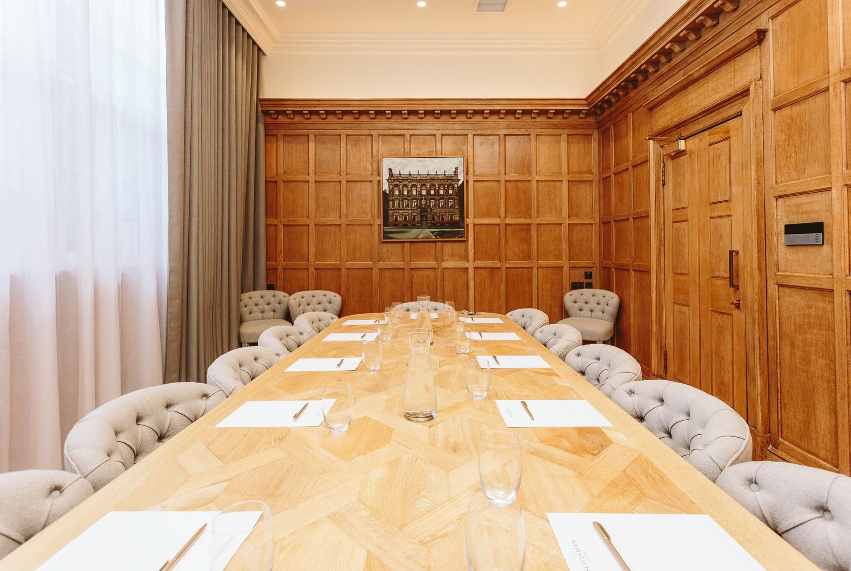 Sophisticated Boardroom at Scotsman Hotel, elegant wooden table for corporate meetings.