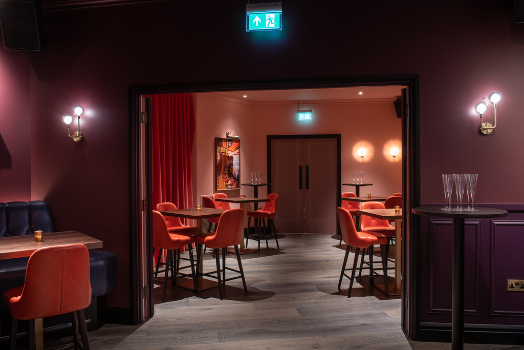 Stylish event space at Puttshack Bank with vibrant seating for private gatherings.