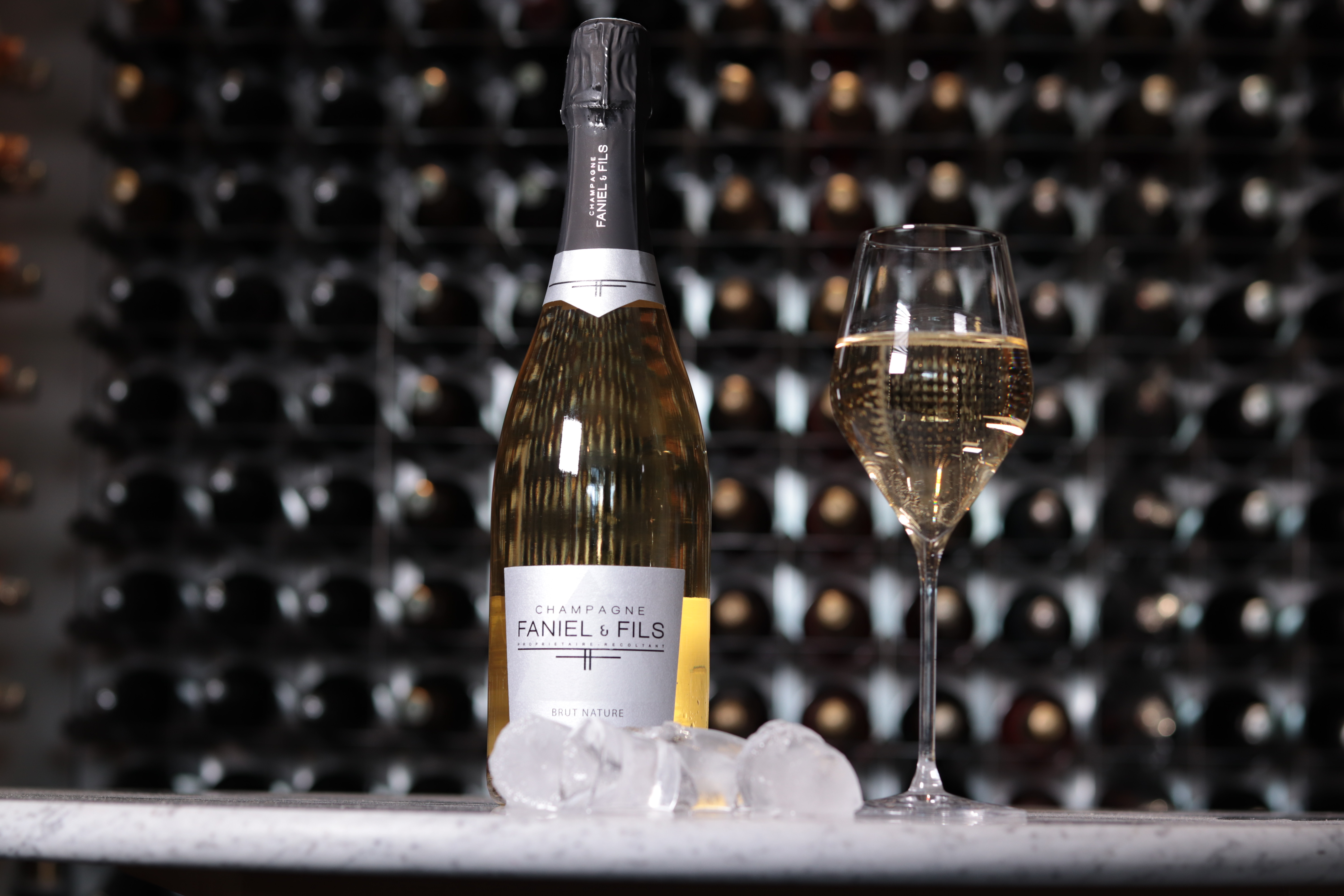 Elegant sparkling wine bottle and glass in upscale venue for events and celebrations.