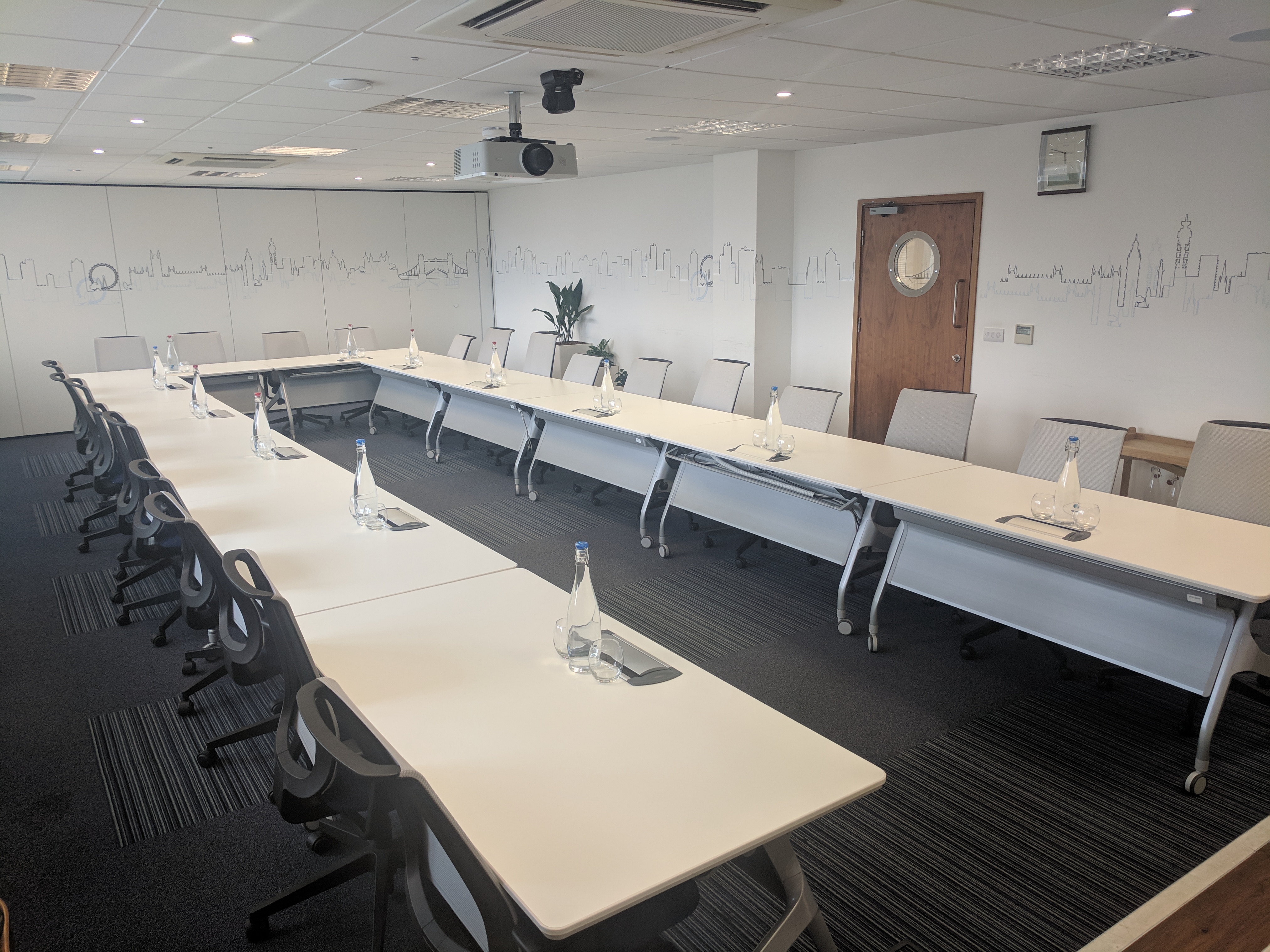 Well-organized meeting room with U-shaped table for professional gatherings and collaboration.