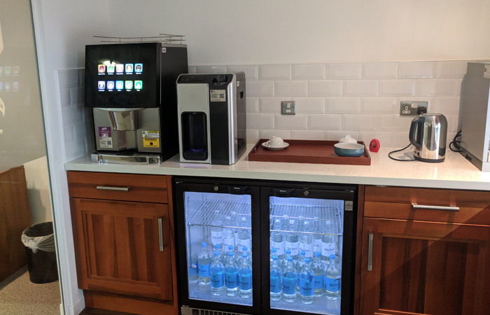 Boardroom refreshment station with coolers and coffee for meetings and events.
