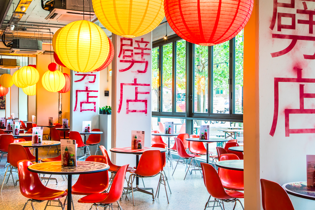 Vibrant event space with colorful lanterns, ideal for networking and workshops.