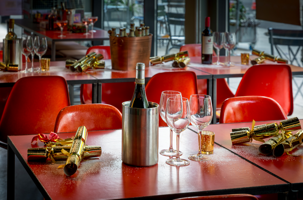 Vibrant event space in Village Vanguard with red chairs, ideal for celebrations and networking.