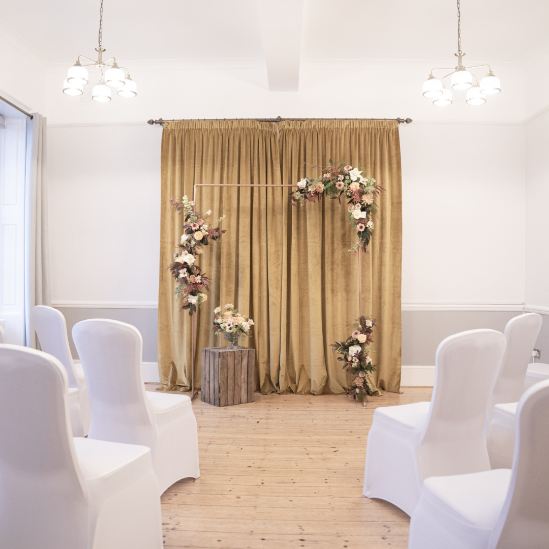 Captains Room at Linden House with floral backdrop, perfect for weddings and events.