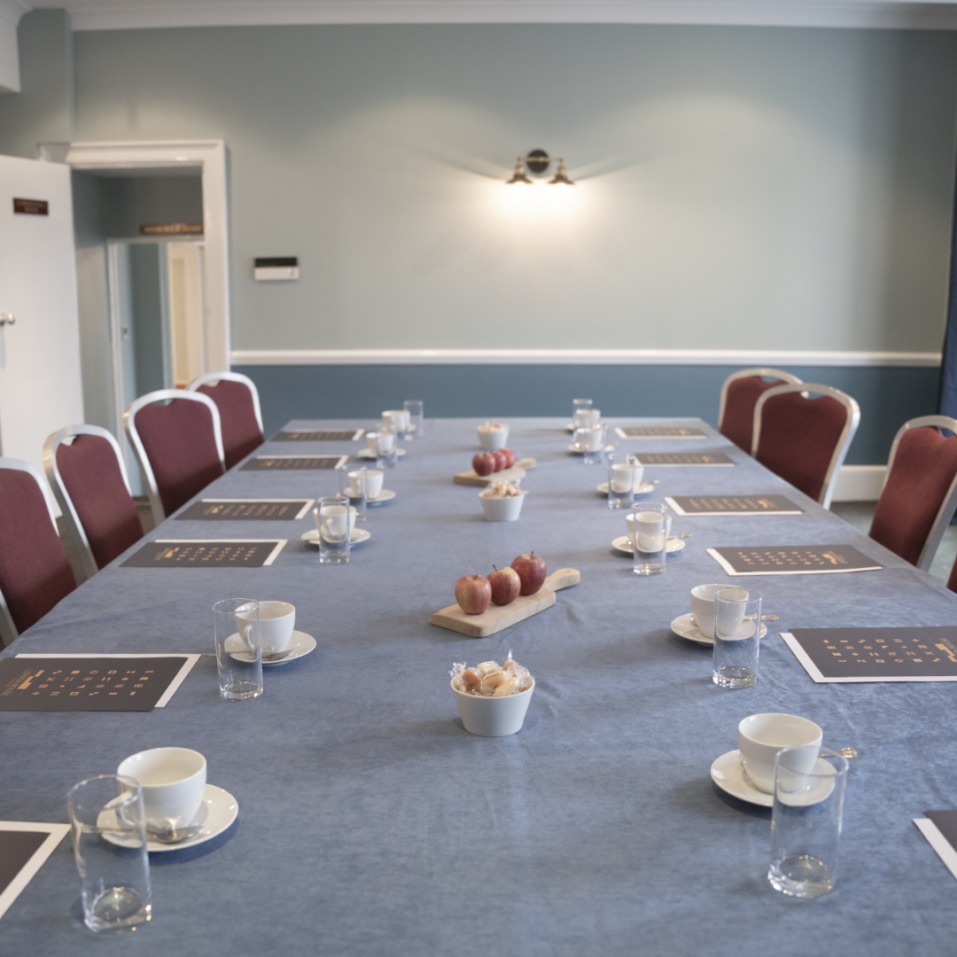 Commodores Room meeting setup with blue tablecloth, ideal for professional gatherings.