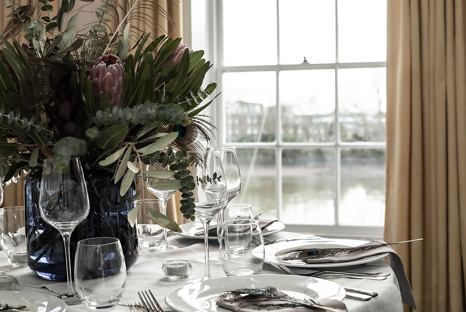 Elegant dining table with floral centerpiece in Commodores Room, perfect for events.