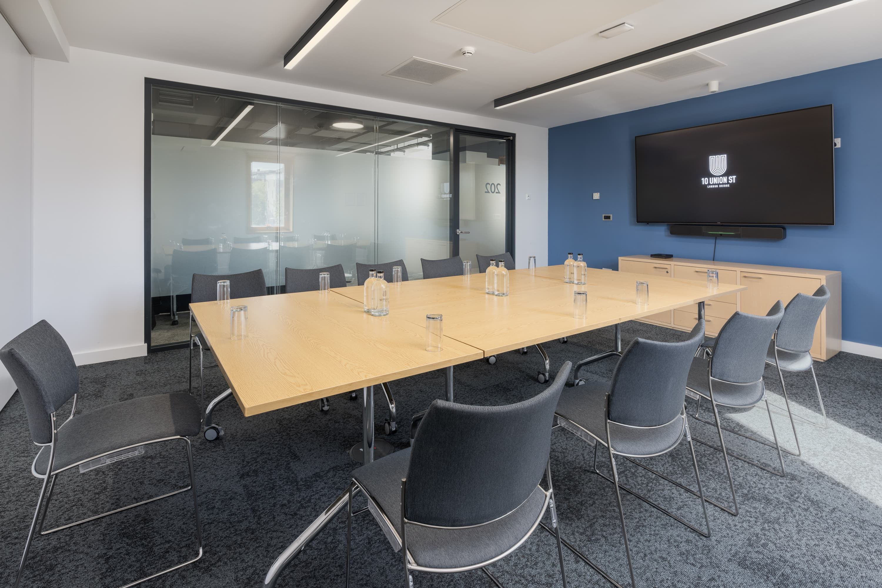 Modern boardroom at 10 Union Street with modular tables for hybrid meetings and collaborative events.