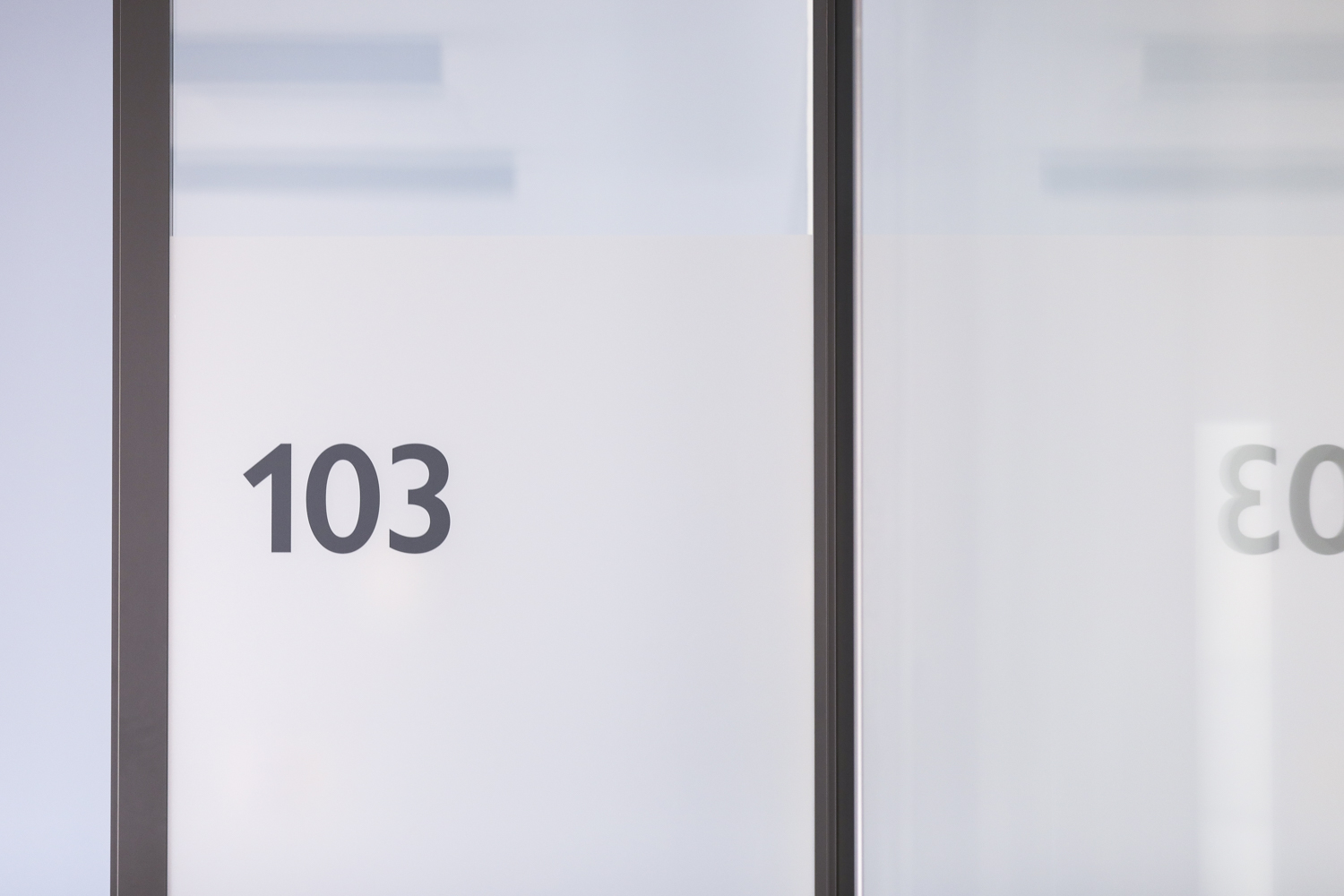 Frosted glass doors 103-104 in modern meeting space for workshops and conferences.