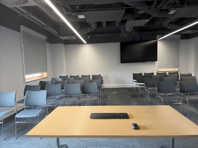 Theater-style event room at 10 Union Street with wall-mounted AV for professional meetings.