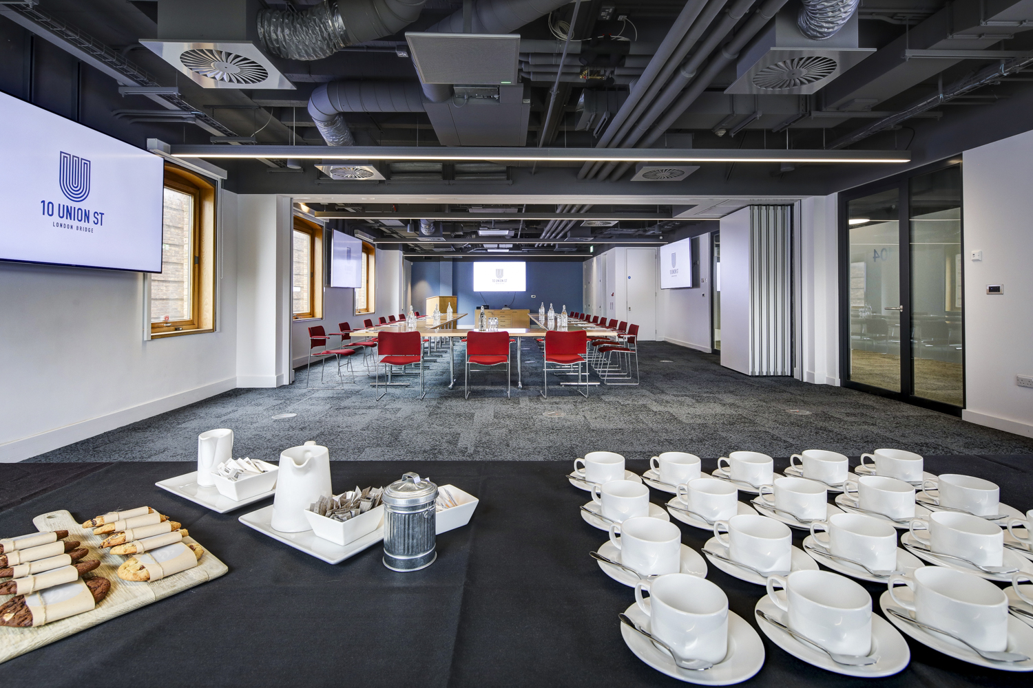 Meeting space with circular seating and refreshments for professional gatherings.