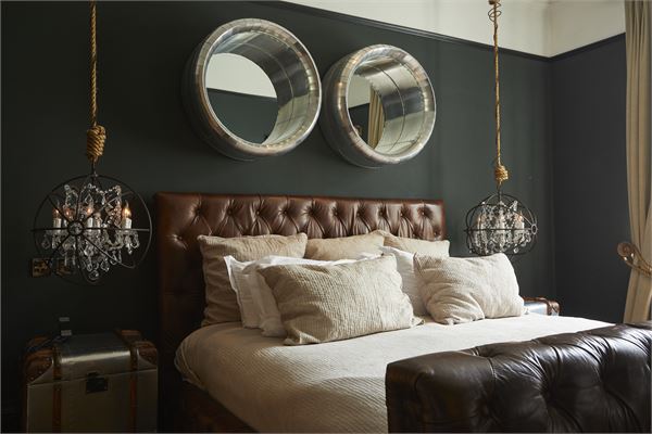 Stylish bedroom with tufted bed at Glazebrook House for intimate events and retreats.